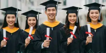 Graduates celebrating with diplomas, ready for student loan repayment